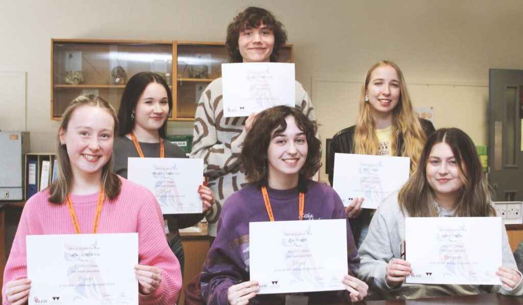Image of biology students with their certificates